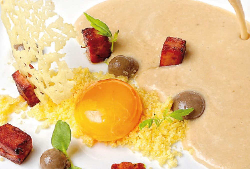 Crema de cebolla de Fuentes de Ebro con yema de huevo, migas de patata y perlas de trufa